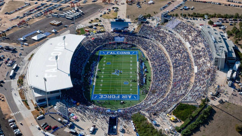 Aerial view of Falcon Stadium at the U.S. Air Force Academy on game day, with full parking lots around it