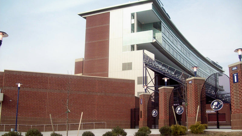 The brick west side and press tower of InfoCision Stadium in Akron, seen from the lawn outside the gates