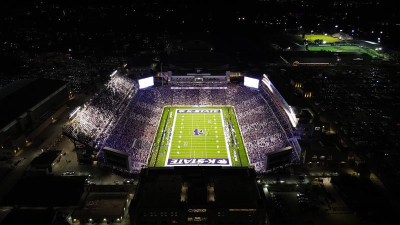 Bill Snyder Family Stadium lit up at night, seen from above