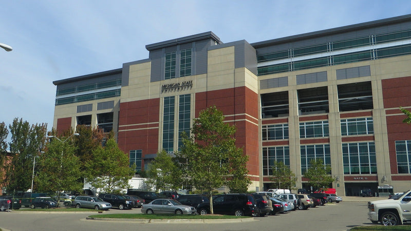 The west side of Spartan Stadium and a parking lot in East Lansing, Michigan