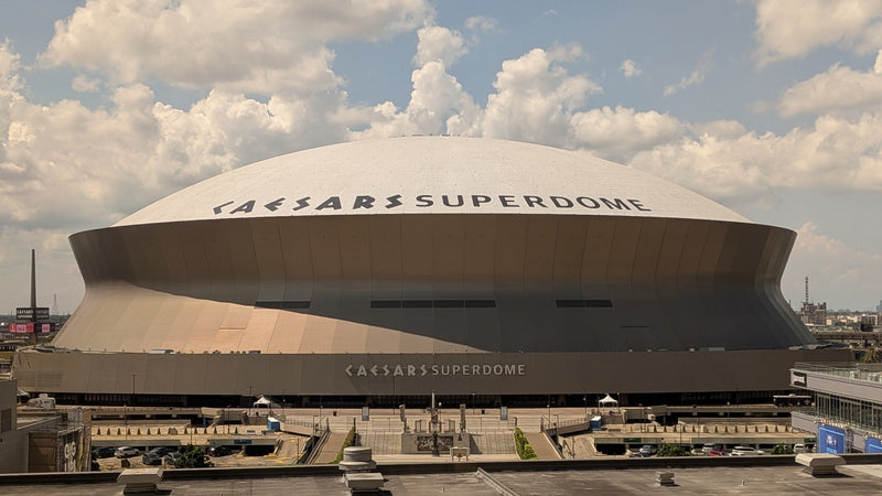 Caesars Superdome in New Orleans under a cloudy sky