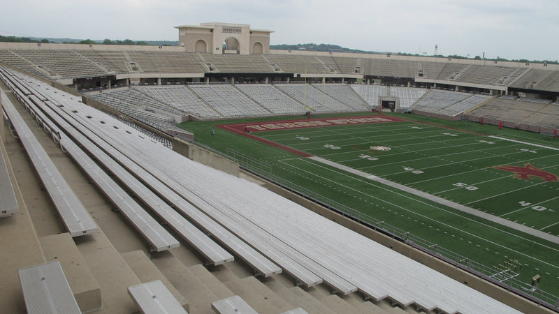 Inside UFCU Stadium in San Marcos, looking across the empty stands and field toward the south end
