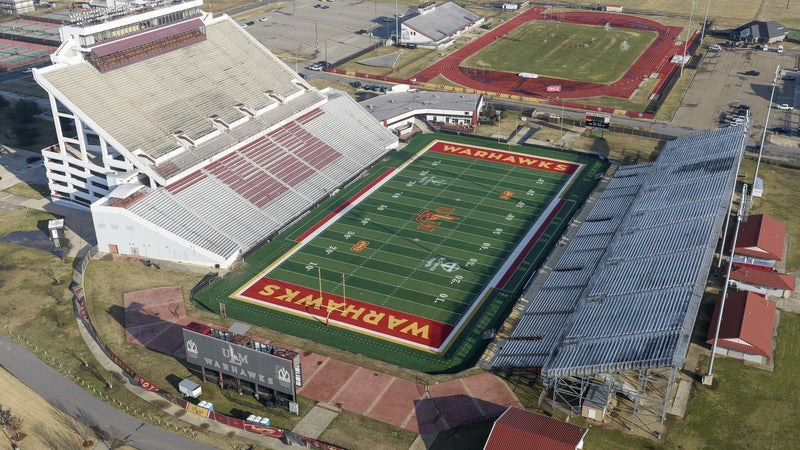 Aerial view of the ULM football stadium in Monroe, with WARHAWKS in both end zones and Brown Stadium's track behind