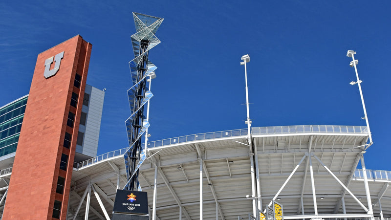 The Olympic cauldron and a Block U tower outside Rice-Eccles Stadium in Salt Lake City