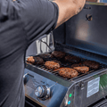 Load image into Gallery viewer, Man grilling a full load of burgers on a tabletop grill set in a pickup truck bed