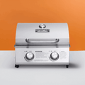 Load image into Gallery viewer, Front view of the stainless tabletop grill on an orange and white backdrop