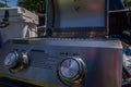 Load image into Gallery viewer, Close-up of the two burner knobs and lighting instructions on the control panel, in a truck bed