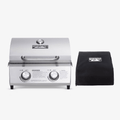 Load image into Gallery viewer, Stainless tabletop grill shown next to a black Monument grill cover