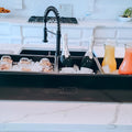 Load image into Gallery viewer, Black three-section cooler on a marble kitchen island with pastries, two bottles of sparkling wine and juice carafes