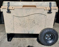 Load image into Gallery viewer, Back of the tan cooler on the wheel kit, black latches up top and a knobby wheel on one side