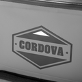 Load image into Gallery viewer, Close-up of the hexagon Cordova logo printed on the gray backpack cooler