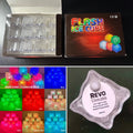 Load image into Gallery viewer, Open box of 12 clear cubes beside its printed box, a color-mode grid, and a close-up of a cube's Revo label
