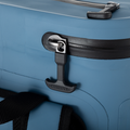 Load image into Gallery viewer, Close-up of the slate-blue backpack cooler's main zipper pull, a black T-handle locked in a metal ring