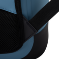 Load image into Gallery viewer, Close-up of a padded black shoulder strap joining the side of the slate-blue backpack cooler