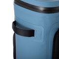 Load image into Gallery viewer, Close-up of a black webbing grab handle stitched to the side of the slate-blue backpack cooler