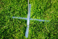 Load image into Gallery viewer, Cross-shaped metal base pressed into grass with the scorekeeper's pole rising from the center