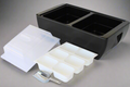 Load image into Gallery viewer, Empty black two-compartment cooler with a clear dome lid, three white divided condiment trays and an aluminum ice scoop