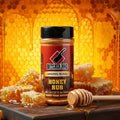 Load image into Gallery viewer, Honey Rub shaker on a wood board in front of honeycomb dripping with honey and a wooden dipper