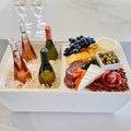 Load image into Gallery viewer, White cooler with rosé and white wine on ice on one side and a cheese and salami board on the other