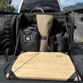 Load image into Gallery viewer, Daylodge Workspace bags and a bamboo prep board set up on a truck tailgate