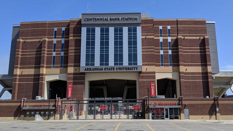 The brick west facade of Centennial Bank Stadium in Jonesboro, with the stadium name above the main gateway