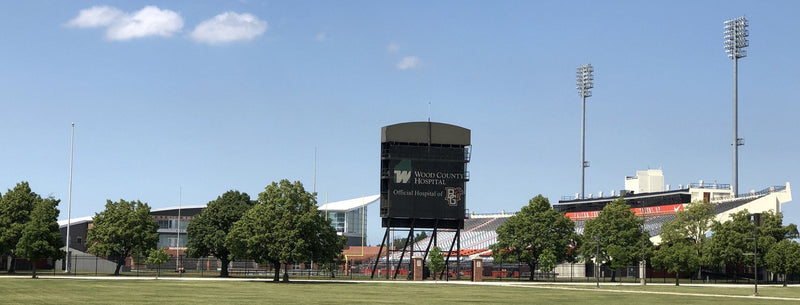 Doyt L. Perry Stadium in Bowling Green, seen across the grass with its scoreboard and light towers