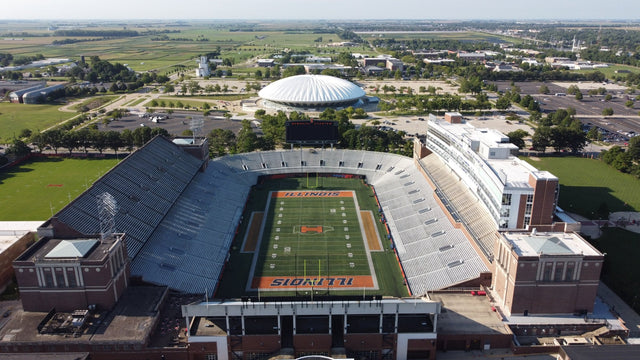Aerial view of Gies Memorial Stadium with the State Farm Center and its parking lots behind it in Champaign