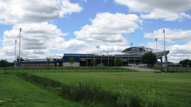 Dix Stadium in Kent seen from across the open grass behind the stadium on a bright summer day