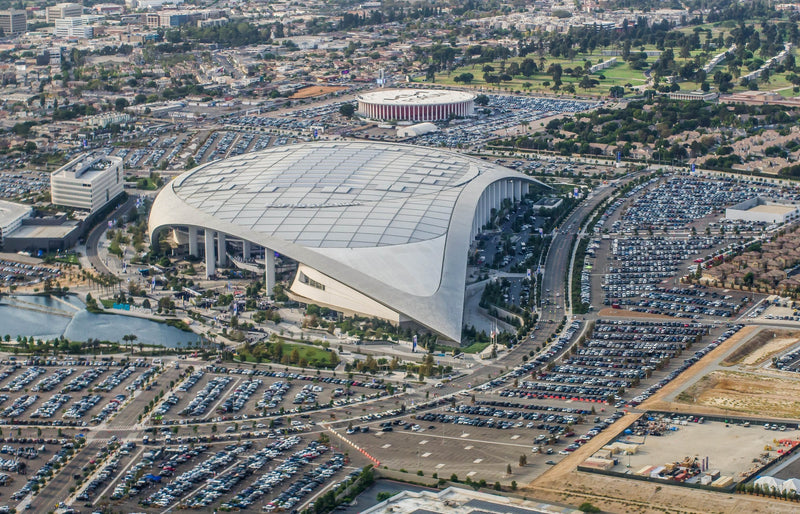 SoFi Stadium in Inglewood from the air, with its parking zones and the Forum behind it