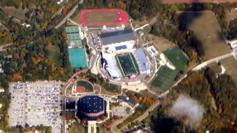 Aerial view of Yager Stadium and Millett Hall in Oxford, Ohio, with the big Millett parking lot beside them, in October
