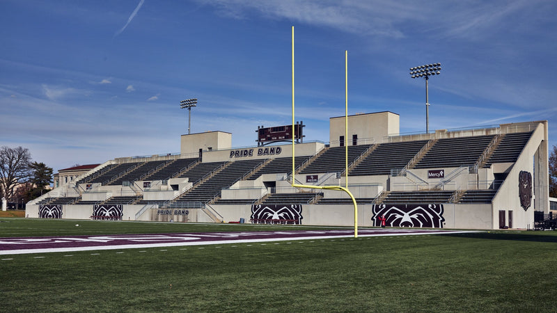 The stands at Robert W. Plaster Stadium in Springfield under a blue sky, seen from the field