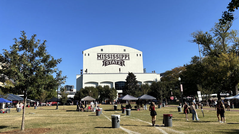 Tailgate tents on a lawn below the south end of Davis Wade Stadium in Starkville