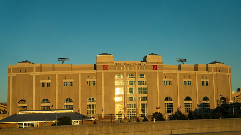 The west face of Memorial Stadium in Lincoln at sunset