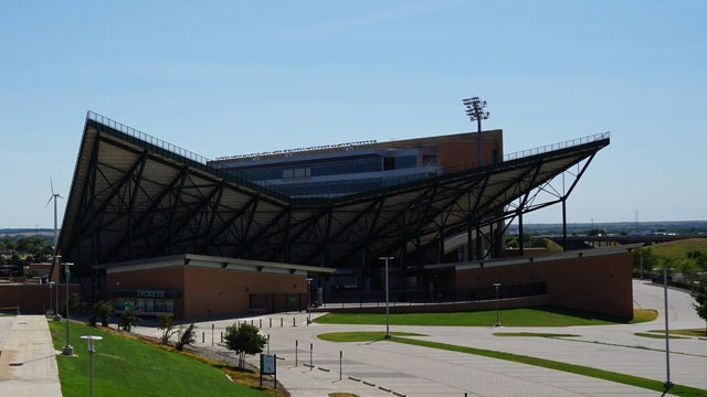 The DATCU Stadium grandstand and ticket windows seen from the walkway on The Hill in Denton