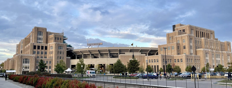 Notre Dame Stadium between the Campus Crossroads buildings, seen from the south lots
