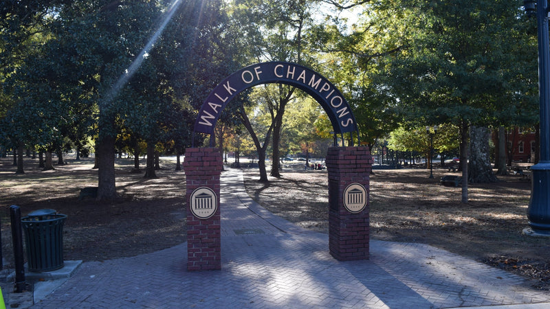 The Walk of Champions arch at the edge of the Grove at Ole Miss