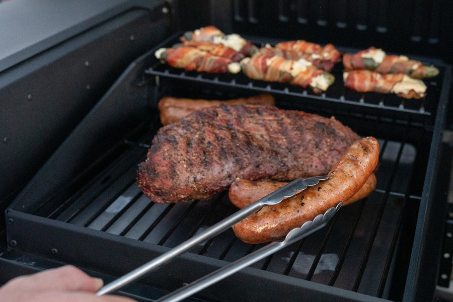 Tri-tip and sausages on the grill at a tailgate