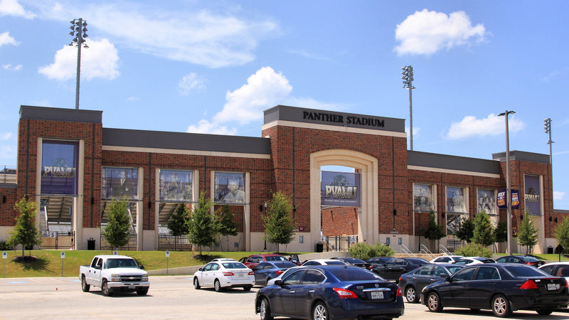 The brick main facade of Panther Stadium at Blackshear Field in Prairie View, Texas, with a parking lot in front