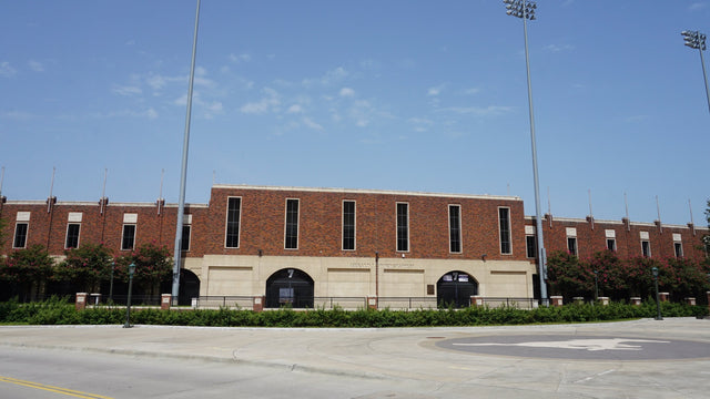 The brick west side of Gerald J. Ford Stadium at SMU, with the stadium name above the gates