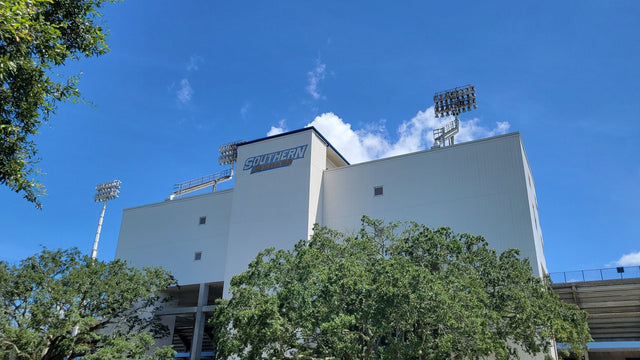Exterior of A.W. Mumford Stadium on the Southern University campus in Baton Rouge, behind live oaks