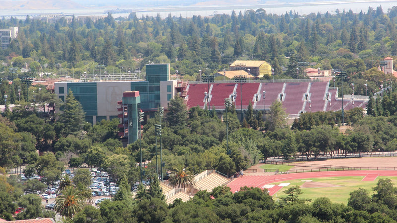 Stanford Stadium among the trees of the Stanford campus, seen from above