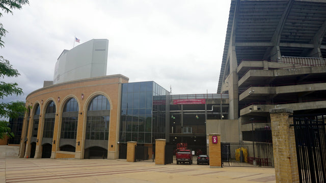 The brick arches of Camp Randall Stadium's south end beside Gate 5, with the east grandstand rising at right