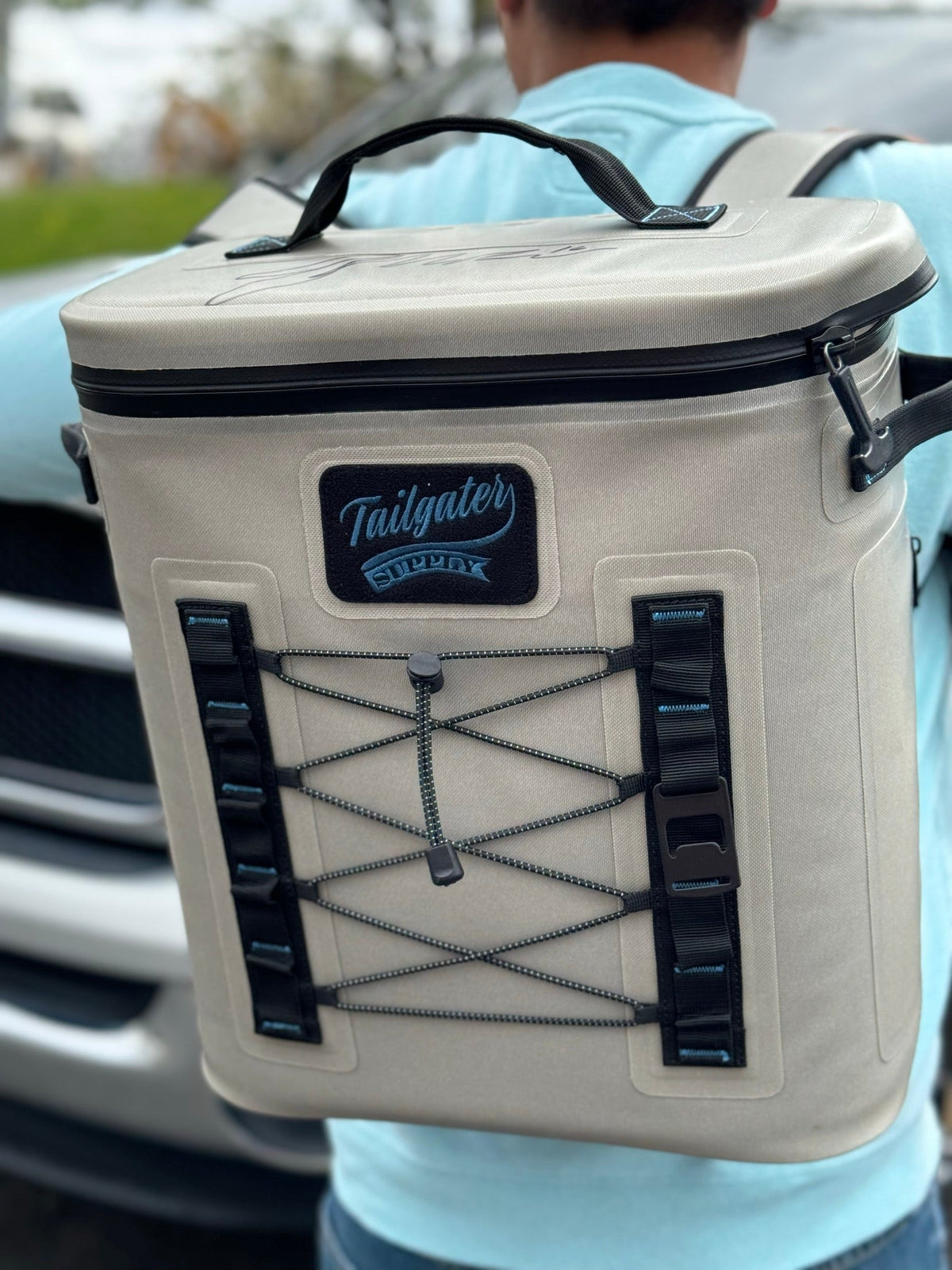 A fan wearing the Tailgate Trekker backpack cooler at a tailgate