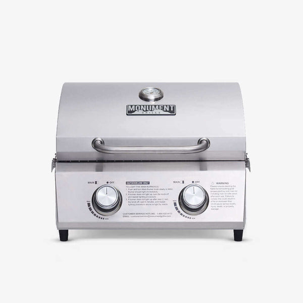 Front view of an all-stainless tabletop grill with a solid lid, lid thermometer and two knobs