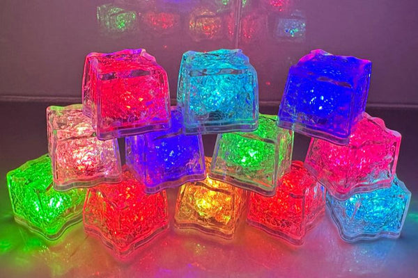 Twelve clear ice-cube-shaped lights stacked in a pyramid, glowing red, blue, green, aqua, pink and yellow