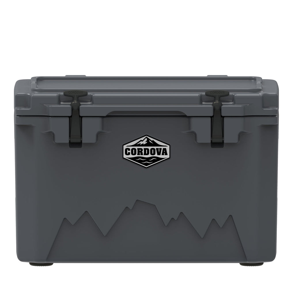 Charcoal gray hard cooler from the front, two black rubber latches, a Cordova badge and a mountain graphic
