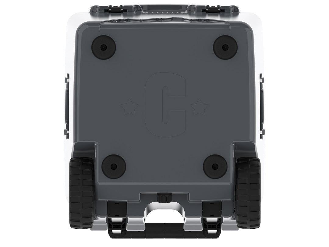 Underside of the charcoal gray wheeled cooler showing rubber feet, wheels and a molded C logo