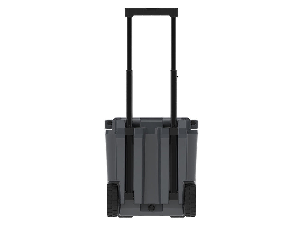 Back of the charcoal gray wheeled cooler with the telescoping handle raised between two wheels