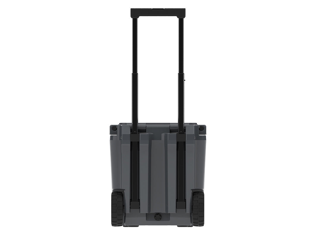 Back of the charcoal gray wheeled cooler with the telescoping handle raised between two wheels