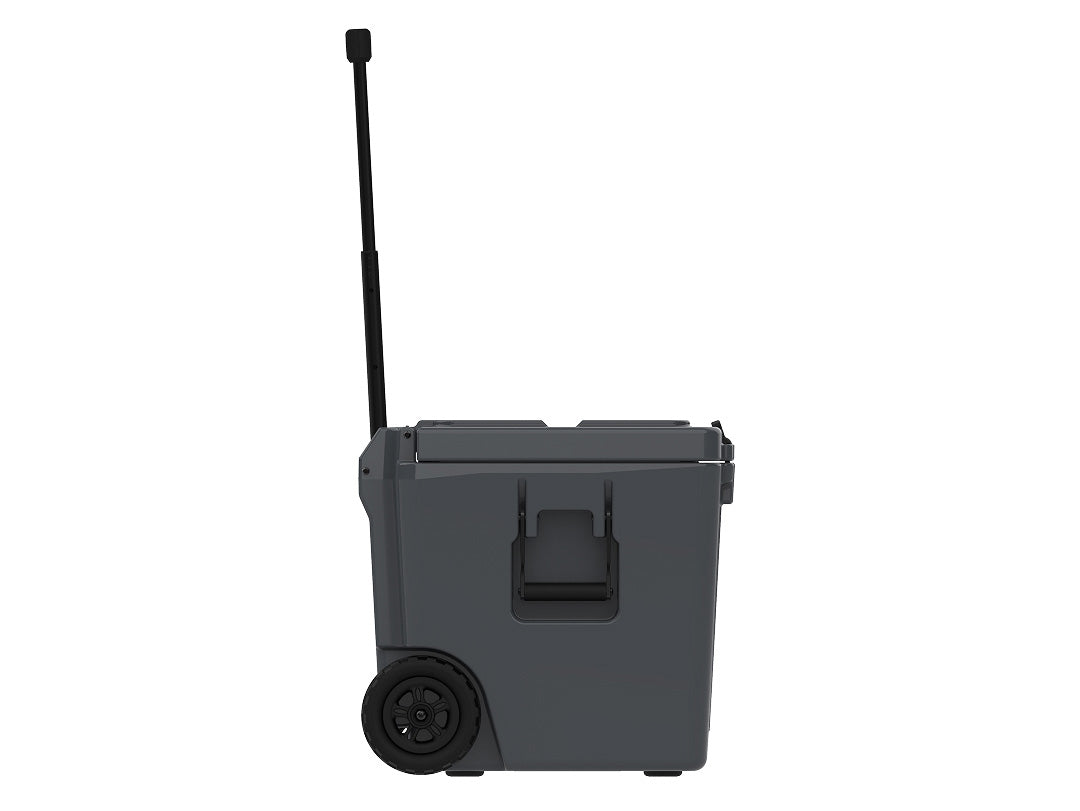 Side view of the charcoal gray wheeled cooler with the handle raised and one wheel showing